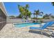 Backyard pool area with pavers, lounge chairs, and privacy fencing at 827 Virginia St, Dunedin, FL 34698