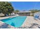Backyard pool and screened-in porch offer an outdoor oasis for relaxation and entertainment at 827 Virginia St, Dunedin, FL 34698