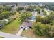 Aerial view of a home with a long drive, mature trees, and neighborhood at 8512 Longboat Ln, Hudson, FL 34667