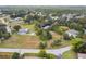 An aerial view of a residential neighborhood with mature trees, lush lawns, and diverse homes, showcasing a peaceful community at 8512 Longboat Ln, Hudson, FL 34667