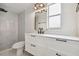 Modern bathroom with marble tiled shower, floating vanity and matte black fixtures at 8512 Longboat Ln, Hudson, FL 34667