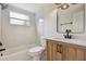 Bathroom showcasing a tub, vanity, sleek fixtures, and natural light at 8512 Longboat Ln, Hudson, FL 34667