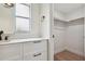 Stylish bathroom vanity with drawers, modern fixtures, and a walk-in closet view at 8512 Longboat Ln, Hudson, FL 34667