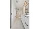 Updated bathroom with white marble floors, shower stall, sleek black fixtures, and modern vanity at 8512 Longboat Ln, Hudson, FL 34667