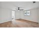 Bright bedroom with hardwood floors, ceiling fan, and ensuite bathroom at 8512 Longboat Ln, Hudson, FL 34667
