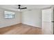 Bright bedroom with hardwood floors, ceiling fan, and a window with a view at 8512 Longboat Ln, Hudson, FL 34667