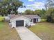Exterior view of home featuring landscaping and attached garage at 8512 Longboat Ln, Hudson, FL 34667