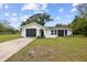 Charming single-story home boasts a modern exterior with a well-maintained front yard at 8512 Longboat Ln, Hudson, FL 34667