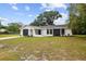 Charming single-story home boasts a modern exterior with a well-maintained front yard at 8512 Longboat Ln, Hudson, FL 34667