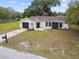 Aerial view of home featuring front yard with mailbox and mature landscaping at 8512 Longboat Ln, Hudson, FL 34667