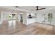 Living room and kitchen combo with hardwood flooring, stainless appliances, and french doors at 8512 Longboat Ln, Hudson, FL 34667