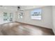 Spacious living area with hardwood floors, a ceiling fan, and lots of natural light at 8512 Longboat Ln, Hudson, FL 34667
