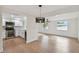Living room and kitchen combo featuring stainless appliances, hardwood flooring, and open concept design at 8512 Longboat Ln, Hudson, FL 34667