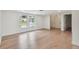 Bright living room with beautiful hardwood floors, large windows, and neutral color palette at 8512 Longboat Ln, Hudson, FL 34667