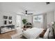 Cozy main bedroom with ceiling fan, natural light, and ensuite bathroom entrance at 8512 Longboat Ln, Hudson, FL 34667