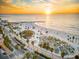 Wonderful view of a beach, ocean, and street with palm trees under a sunset at 864 Mandalay Ave, Clearwater Beach, FL 33767