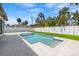 Backyard oasis with a sparkling pool and lush greenery, perfect for relaxing and enjoying the outdoors at 864 Mandalay Ave, Clearwater Beach, FL 33767