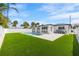 A well-maintained backyard featuring a sparkling pool and a modern design, perfect for outdoor relaxation at 864 Mandalay Ave, Clearwater Beach, FL 33767