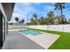 Picturesque backyard showcasing a refreshing pool and a manicured lawn, ideal for leisure and recreation at 864 Mandalay Ave, Clearwater Beach, FL 33767