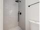 Modern bathroom features a tiled shower, matte black fixtures, and white subway tiles at 864 Mandalay Ave, Clearwater Beach, FL 33767