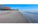 A lovely view of the beach on a beautiful day with blue sky, ocean, and nearby buildings at 864 Mandalay Ave, Clearwater Beach, FL 33767