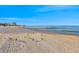 A beautiful beach scene with white sand and clear blue water at 864 Mandalay Ave, Clearwater Beach, FL 33767