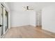 A clean and spacious bedroom features ample natural light and wood look floors at 864 Mandalay Ave, Clearwater Beach, FL 33767