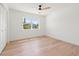 Bright bedroom with hardwood floors, ceiling fan, and a large window offering outside views at 864 Mandalay Ave, Clearwater Beach, FL 33767