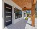 Close-up of the front porch showcasing modern design, dark trim windows and decorative tile work at 864 Mandalay Ave, Clearwater Beach, FL 33767