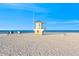 Beautiful view of white sand with a lifeguard stand, blue sky, and ocean in the background at 864 Mandalay Ave, Clearwater Beach, FL 33767