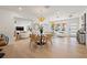 Open-concept living and dining areas with hardwood floors and modern light fixtures provide an airy, inviting space at 864 Mandalay Ave, Clearwater Beach, FL 33767