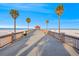 Beautiful view of a pier on a sunny day with blue sky and palm trees at 864 Mandalay Ave, Clearwater Beach, FL 33767