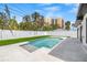 Backyard pool area with a sleek pool and lush, manicured lawn for a refreshing outdoor experience at 864 Mandalay Ave, Clearwater Beach, FL 33767