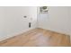 Empty room with hardwood floors, neutral walls, and a window for laundry hookups at 864 Mandalay Ave, Clearwater Beach, FL 33767