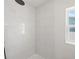 Clean, tiled shower stall with modern fixtures and a window at 864 Mandalay Ave, Clearwater Beach, FL 33767