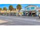 Street view capturing the charming stores and restaurants, enhanced by palm trees, creating a vibrant atmosphere at 864 Mandalay Ave, Clearwater Beach, FL 33767