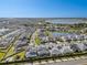 Aerial view showcasing community with ponds and neighborhood homes on a sunny day at 8720 Drummer Plank Dr, Wesley Chapel, FL 33545