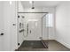 Modern bathroom features include a glass shower, sleek black hardware, and tiled walls at 8720 Drummer Plank Dr, Wesley Chapel, FL 33545