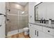 Bright bathroom with tile shower and modern vanity with granite countertop at 8720 Drummer Plank Dr, Wesley Chapel, FL 33545