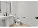 Bathroom with modern fixtures, pedestal sink, and tile flooring at 8720 Drummer Plank Dr, Wesley Chapel, FL 33545