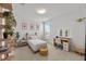 Bright bedroom with a single bed, lighted mirror, hanging chair, and stylish decor at 8720 Drummer Plank Dr, Wesley Chapel, FL 33545