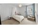 Bright bedroom with a double bed, night stand, accent chair and stylish decor at 8720 Drummer Plank Dr, Wesley Chapel, FL 33545