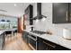 Close up on a modern kitchen featuring stainless steel appliances and quartz countertops with adjacent dining area at 8720 Drummer Plank Dr, Wesley Chapel, FL 33545