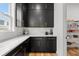Kitchen with stainless steel appliances, quartz countertops, black cabinets and a walk-in pantry at 8720 Drummer Plank Dr, Wesley Chapel, FL 33545