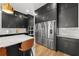 Modern kitchen with sleek black cabinetry, stainless steel appliances, and quartz countertops at 8720 Drummer Plank Dr, Wesley Chapel, FL 33545