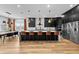 Modern kitchen with sleek black cabinetry, stainless steel appliances, and a large center island with seating at 8720 Drummer Plank Dr, Wesley Chapel, FL 33545