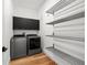 Bright laundry room with new washer and dryer units and hanging racks at 8720 Drummer Plank Dr, Wesley Chapel, FL 33545