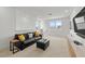 Upstairs living room with black leather sofa, ottoman, and natural light at 8720 Drummer Plank Dr, Wesley Chapel, FL 33545