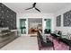 Inviting covered outdoor lounge featuring stainless steel appliances and decorative geometric wall accents at 8720 Drummer Plank Dr, Wesley Chapel, FL 33545