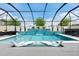 Beautiful pool with a waterfall feature and submerged lounge chairs at 8720 Drummer Plank Dr, Wesley Chapel, FL 33545